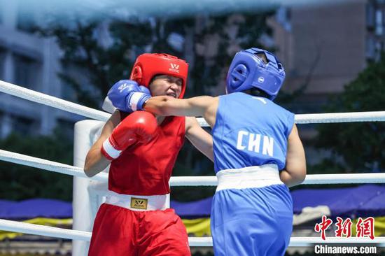 6月16日晚，2024年全国少年(U16)拳击锦标赛-预赛(南半区)在贵州省<a href=//www.hp-dv.com target=_blank class=infotextkey>黔南</a>布依族苗族自治州贵定县乡贤文化广场举行各级别决赛，来自贵州、湖北、重庆、广东、安徽等地的拳击运动员在擂台上展开竞逐。图为贵州运动员张仁靓(蓝衣)和江苏运动员相嫣然在进行女子54-57公斤级决赛。中新社记者 瞿宏伦 摄