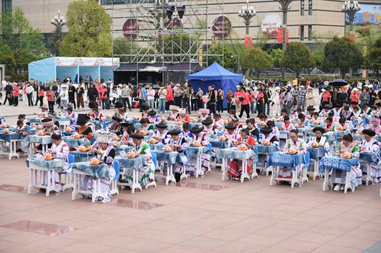 3月30日，首届贵州牛肉粉文化旅游季系列活动上，来自黔西市各乡镇的百名绣娘妇女儿童缝制吉祥物绣“福牛”，向观众和游客展现少数民族的文化魅力。